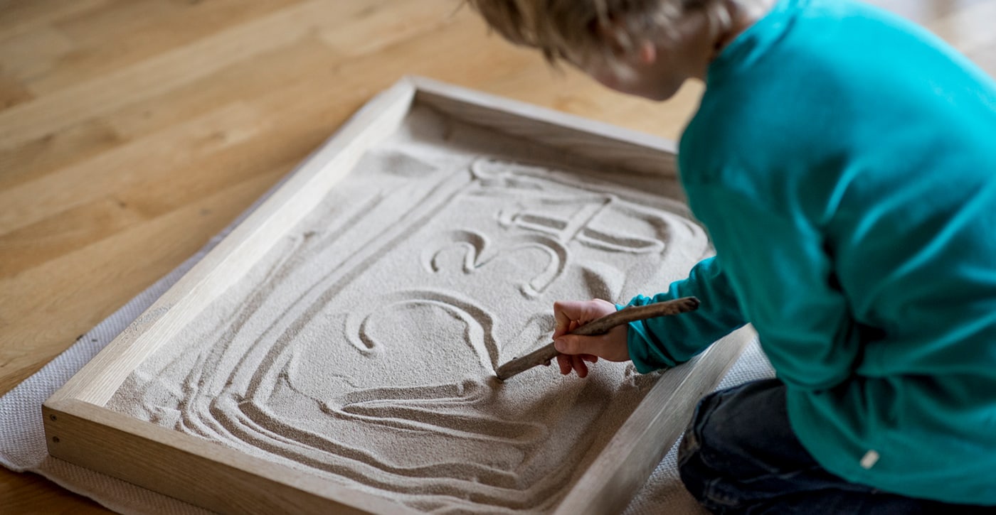 Zahlen im Sand schreiben